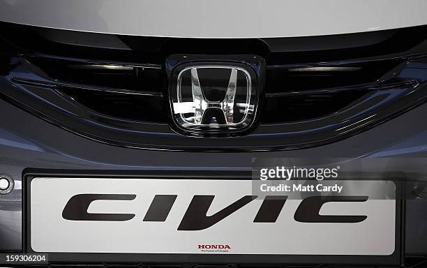 The Honda logo is seen on a Honda Civic displayed in the reception of a office building at the Honda car assembly plant following the announcement...