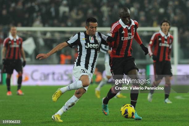 Bakaye Traore of AC Milan in action against Mauricio Isla of Juventus FC during the TIM cup match between Juventus FC and AC Milan at Juventus Arena...
