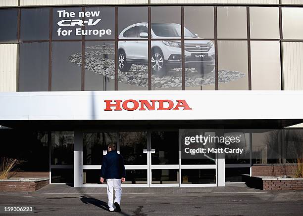 Honda workers walk into a building at the Honda car assembly plant following the announcement that the firm is to axe 800 jobs on January 11, 2013 in...