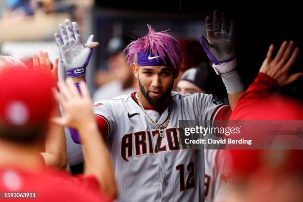 Lourdes Gurriel Jr. #12 of the Arizona Diamondbacks celebrates his solo home run with teammates in the dugout in the second inning against the...