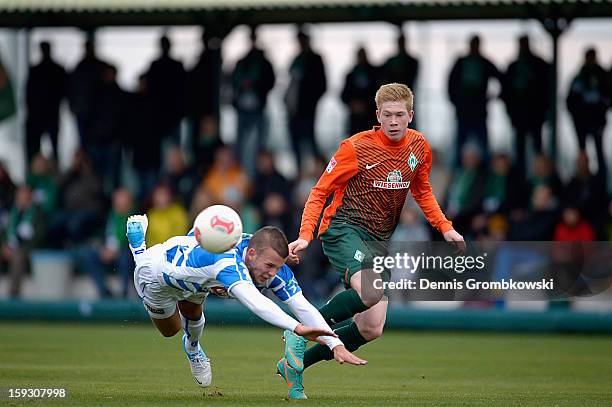 Jesper Drost of Zwolle is challenged by Kevin de Bruyne of Bremen during a friendly match between Werder Bremen and PEC Zwolle on January 11, 2013 in...