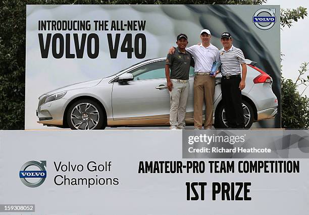 Thongchai Jaidee of Thailand, Amateur Colin Ledworth of England and Louis Oosthuizen of South Africa pose with their prize for winning the...