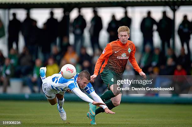 Jesper Drost of Zwolle is challenged by Kevin de Bruyne of Bremen during a friendly match between Werder Bremen and PEC Zwolle on January 11, 2013 in...