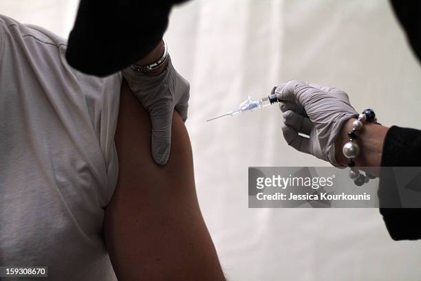 Patient recieves a flu shot at a mobile tent set up to handle the recent influx of flu cases by the Lehigh Valley Health Network's main hospital...