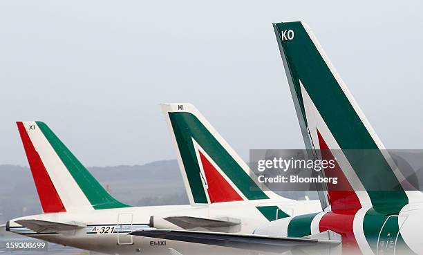 Logos sit on the tailfins of Alitalia SpA aircraft parked at Fiumicino airport in Rome, Italy, on Friday, Jan. 11, 2013. Former Italian Prime...