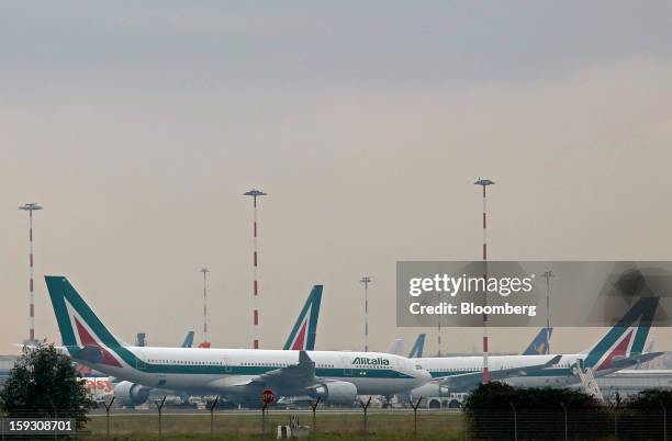 Alitalia SpA aircraft stand on the tarmac at Fiumicino airport in Rome, Italy, on Friday, Jan. 11, 2013. Former Italian Prime Minister Silvio...