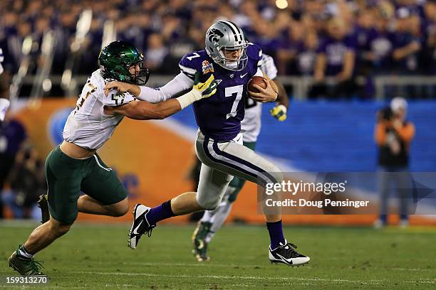 Collin Klein of the Kansas State Wildcats runs the ball against Kiko Alonso of the Oregon Ducks during the Tostitos Fiesta Bowl at University of...