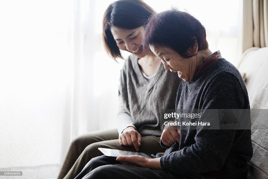 Family watching a digital tablet together