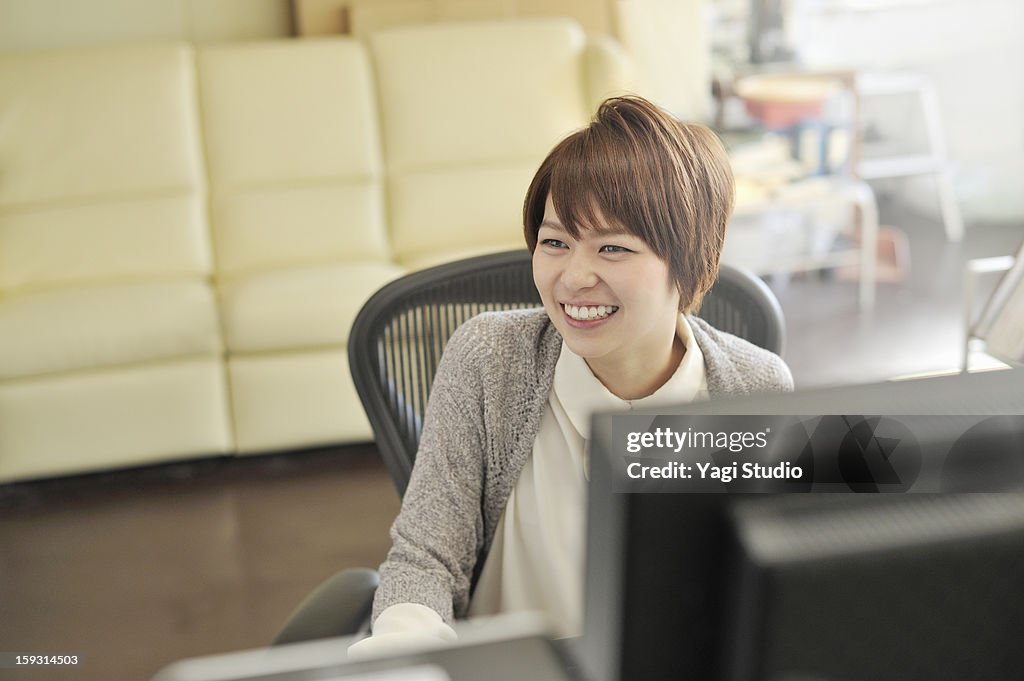 Businesswoman sitting in office,smiling