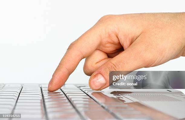 closeup of a hand about to press on a keyboard - senf stock pictures, royalty-free photos & images