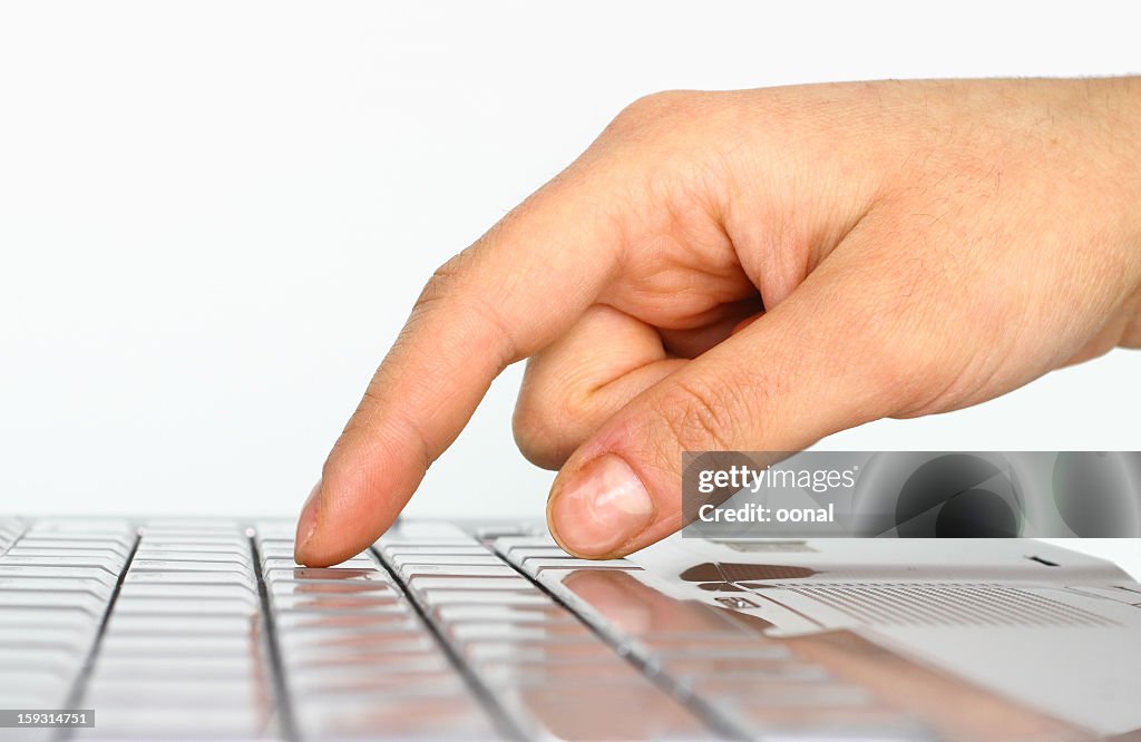 Closeup of a hand about to press on a keyboard