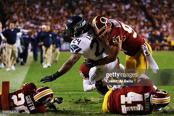 Marshawn Lynch of the Seattle Seahawks scores a fourth quarter touchdown against the defense of Lorenzo Alexander of the Washington Redskins during...