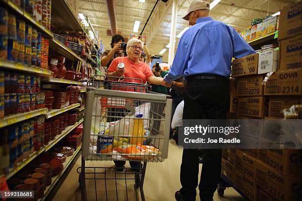 Mirta Sandomingo is greeted by Florida Governor Rick Scott as he visits Sedano’s Supermarket on January 11, 2013 in Miami, Florida. Governor Scott...