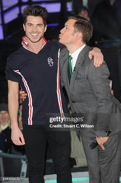 Sam Robertson and Brian Dowling pose after Sam is the second celebrity evicted from the Big Brother house at Elstree Studios on January 11, 2013 in...