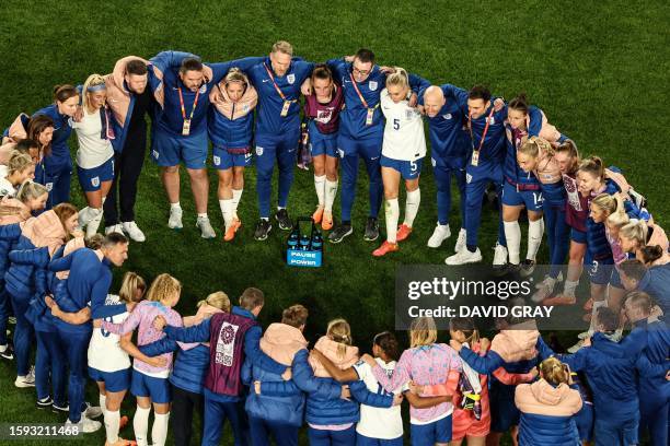 England's players huddle at the end of the Australia and New Zealand 2023 Women's World Cup quarter-final football match between Colombia and England...