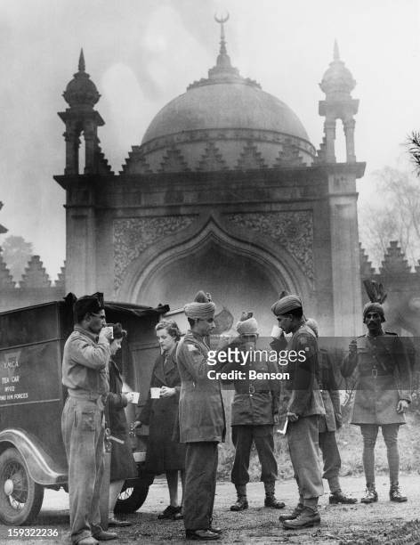 Indian soldiers drinking tea from a mobile canteen outside the Shah Jahan Mosque in Woking, Surrey, during World War II, 28th November 1941.