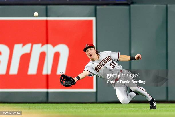 Jake McCarthy of the Arizona Diamondbacks dives for but can't catch a ball hit by Willi Castro of the Minnesota Twins in the sixth inning at Target...