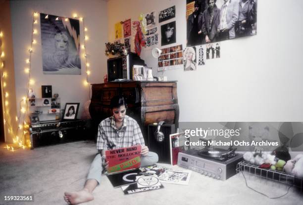 Actress and TV personality Allegra Curtis listens to The Sex Pistols 'Never mind the Bollocks' in her room at home in January 1982 in Los Angeles,...