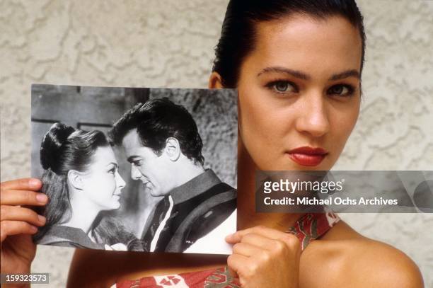 Actress and TV personality Allegra Curtis poses with a photo of her parents, Tony Curtis and Christine Kaufmann in 1988 in Los Angeles, California.