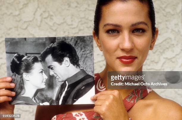 Actress and TV personality Allegra Curtis poses with a photo of her parents, Tony Curtis and Christine Kaufmann in 1988 in Los Angeles, California.