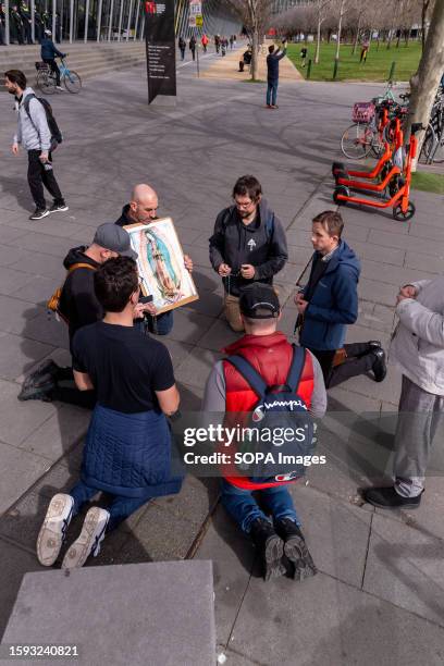 Group of Christian protesters kneel and pray outside the building during demonstrations about the Melbourne Drag Expo at the Melbourne Convention...