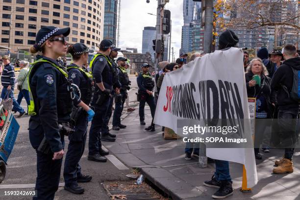 Police keep anti-trans protesters from crossing the street during counter demonstrations at the Melbourne Convention Center. Protesters and counter...