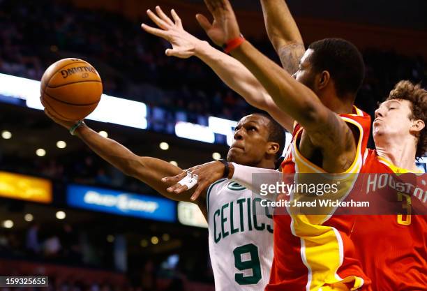 Rajon Rondo of the Boston Celtics goes up for a layup against Omer Asik of the Houston Rockets during the game on January 11, 2013 at TD Garden in...