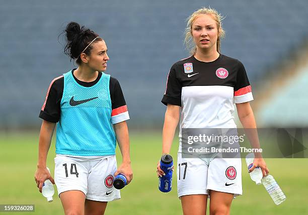 Trudy Camilleri and Alisha Bass of the Wanderers walk back to the change rooms with plenty of water prior to the round 12 W-League match between the...