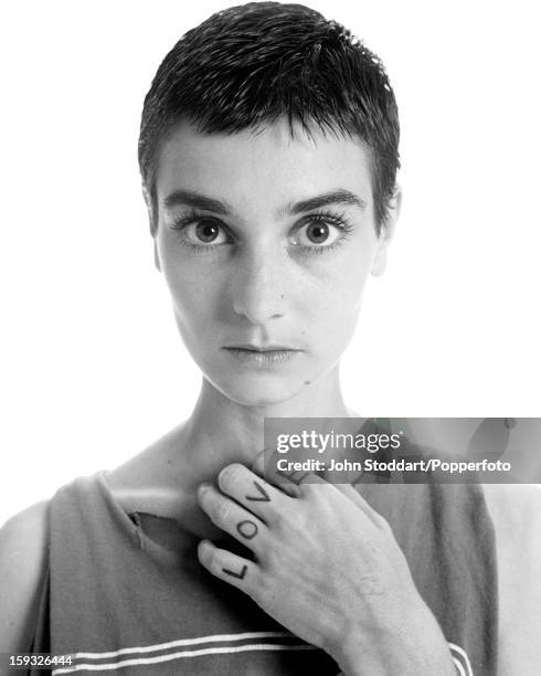 Irish singer and songwriter Sinéad O'Connor with the word 'love' written on her fingers, 1994.