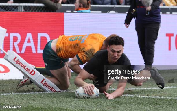 Shaun Stevenson of New Zealand scores a try against Andrew Kellaway of Australia during The Rugby Championship & Bledisloe Cup match between the New...