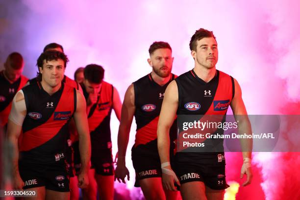 Zach Merrett leads the Bombers out during the round 21 AFL match between Essendon Bombers and West Coast Eagles at Marvel Stadium on August 05, 2023...