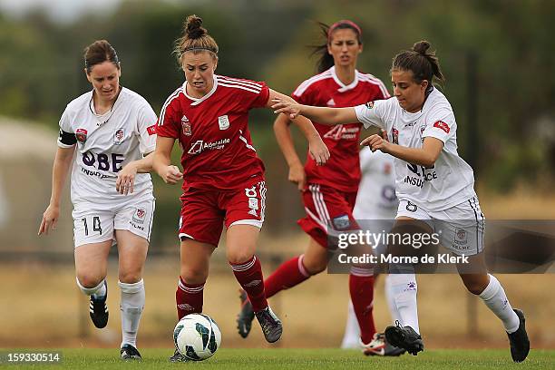 Sarah McLaughlin of Adelaide is put under pressure by Ella Mastantonio of Perth during the round 12 W-League match between Adelaide United and the...