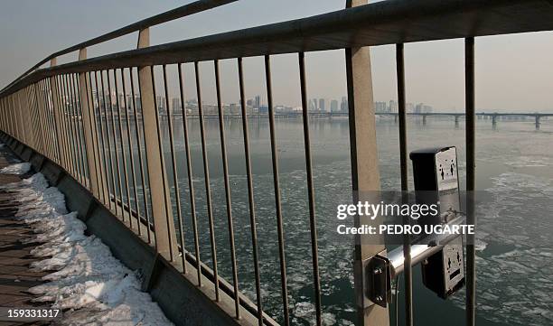 This photo taken on January 11, 2013 shows an anti-suicide monitoring device installed at Mapo Bridge - a common place for suicides- over Seoul's Han...