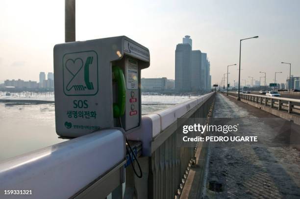 This photo taken on January 11, 2013 shows an emergency telephone placed by the government at Mapo Bridge -a common site for suicides- over Seoul's...