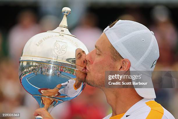 Lleyton Hewitt of Australia kisses the winners trophy after winning his match against Juan Martín del Potro of Argentina during day four of the AAMI...