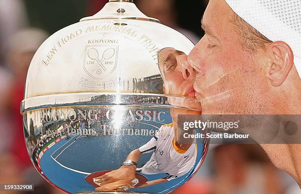 Lleyton Hewitt of Australia kisses the winners trophy after winning his match against Juan Martín del Potro of Argentina during day four of the AAMI...