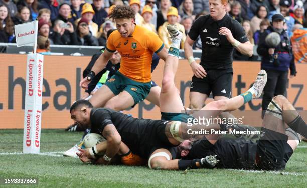 Ardie Savea of New Zealand holds the ball up over the line as Tate McDermott of Australia tries to score during The Rugby Championship & Bledisloe...