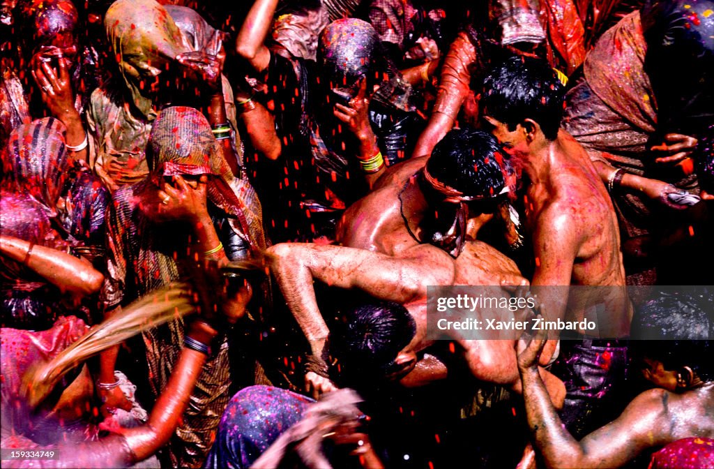 Spring in India, Cheerful Women Beating Men Among Crowds Of Pilgrims Celebrating Holi, Festival Of Colours And Love