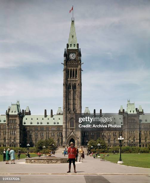 The Peace Tower in the Centre Block of the Canadian parliament buildings in Ottawa, Ontario, Canada, circa 1960. In the centre is a member of the...