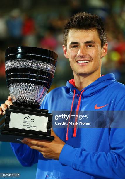 Bernard Tomic of Australia poses with the trophy after winning the Mens singles final against Kevin Anderson of South Africa during day seven of the...