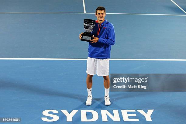 Bernard Tomic of Australia poses with the champions trophy after winning the men's final match against Kevin Anderson of South Africa during day...