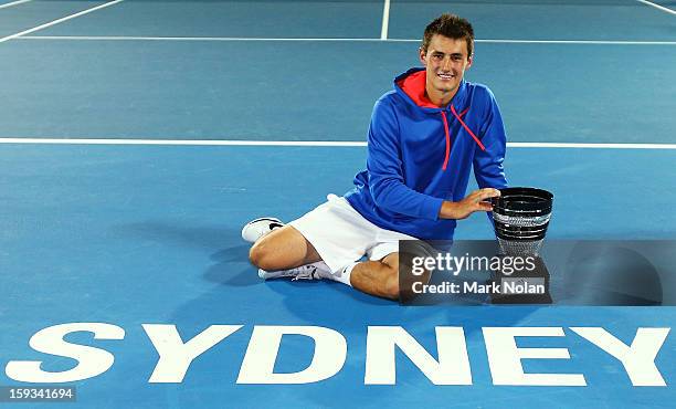 Bernard Tomic of Australia poses with the trophy after winning the Mens singles final against Kevin Anderson of South Africa during day seven of the...