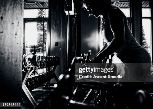 Female Racking Weights Young Woman Lifts Weights Form Rack In Gym High-Res Stock Photo - Getty ...