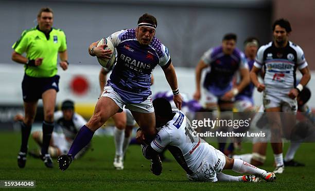 Greg Bateman of London Welsh beats the tackle from Billy Ngawini of I Cavalieri Prato during the Amlin Challenge Cup match between London Welsh and I...