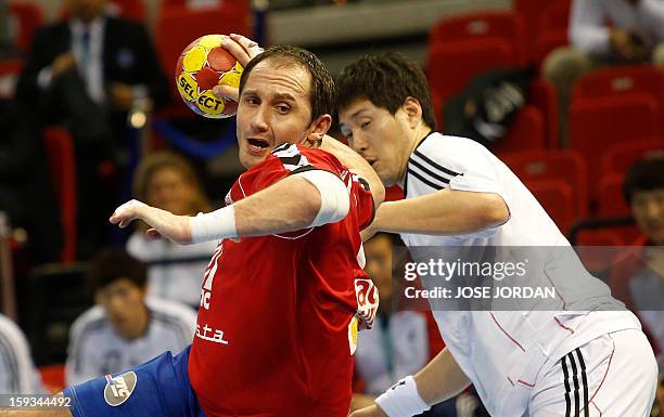Serbia's pivot Alem Toskic vies with Korea's back Chan-Yong Park during the 23rd Men's Handball World Championships preliminary round Group C match...