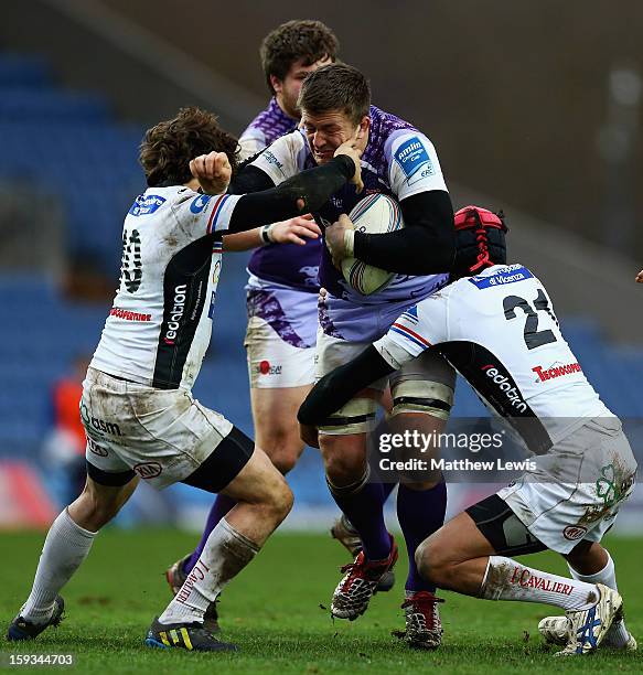 Ed Jackson of London Welsh is tackled by Simone Ragusi and Ivan Crestini of I Cavalieri Prato during the Amlin Challenge Cup match between London...