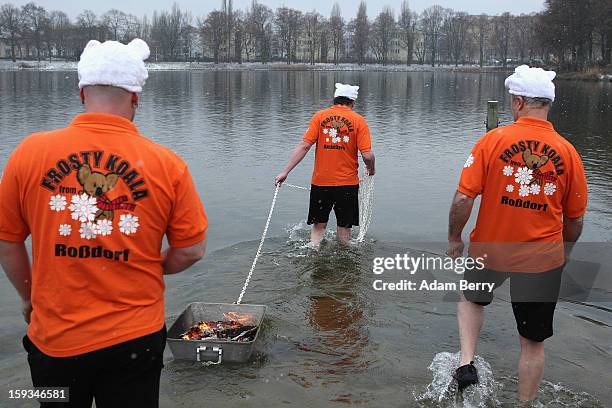 Ice swimming enthusiasts head into the cold waters of Orankesee lake during the 'Winter Swimming in Berlin' event on January 12, 2013 in Berlin,...