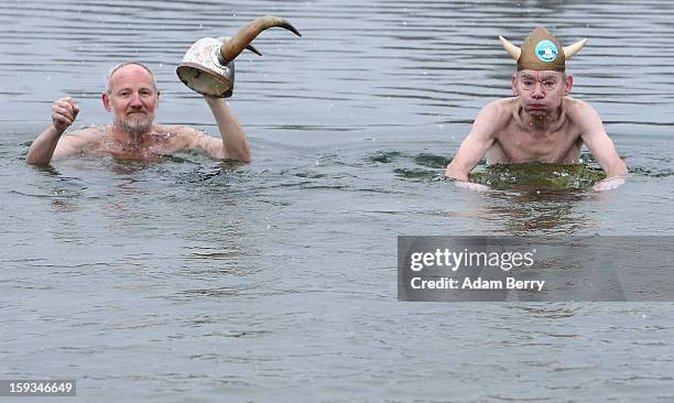 Ice swimming enthusiasts from Denmark dressed as vikings wade in the cold waters of Orankesee lake during the 'Winter Swimming in Berlin' event on...