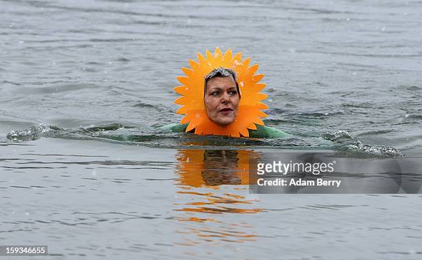 An ice swimming enthusiast wades in the cold waters of Orankesee lake during the 'Winter Swimming in Berlin' event on January 12, 2013 in Berlin,...