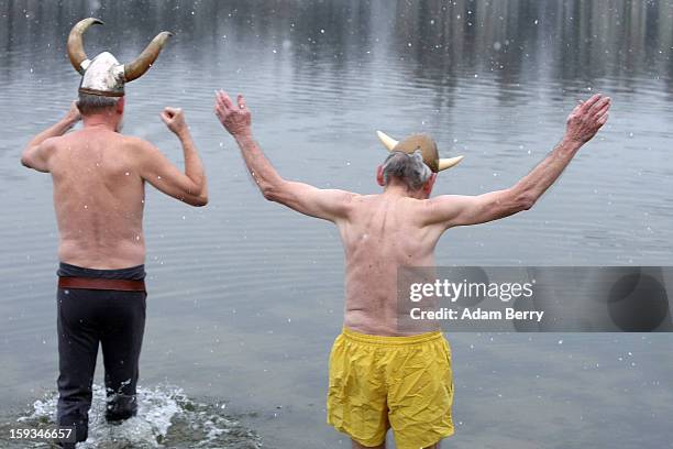 Ice swimming enthusiasts from Denmark dressed as vikings enter the cold waters of Orankesee lake during the 'Winter Swimming in Berlin' event on...